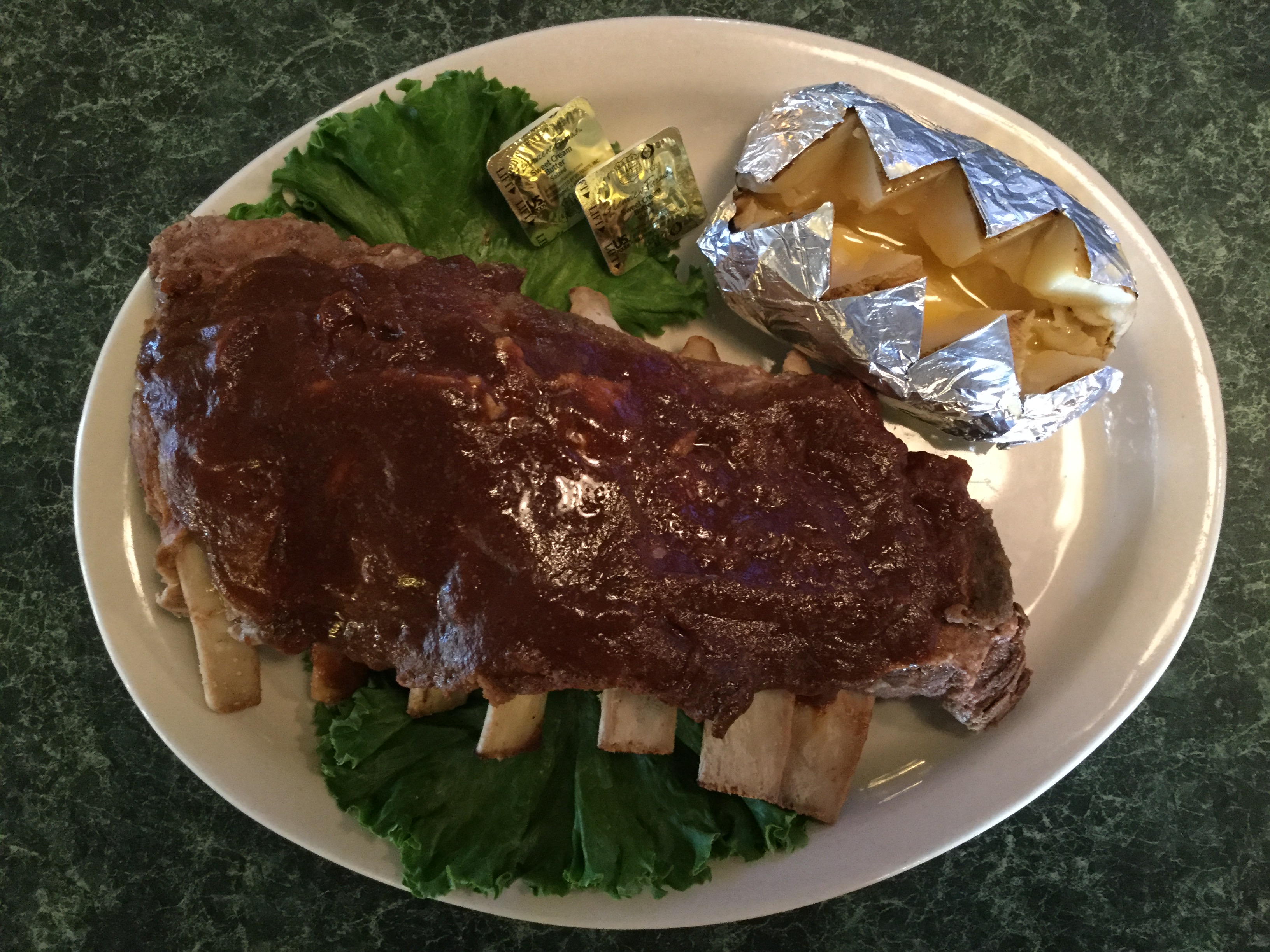 Barbecue ribs and a baked potato served at Circle C Saloon